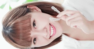 vertical video - Beauty woman smile to you with health teeth and invisible brace
