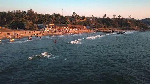 Aerial Drone Pulling Away Slowly 60fps from popular tourist Candolim beach area in North Goa