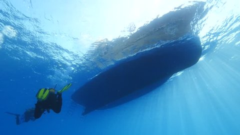scuba diver ascending back to boat underwater dive