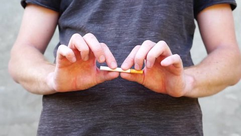 man breaks a cigarette to quit Smoking