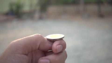 Man tossing a coin in slow motion