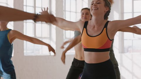 beautiful caucasian woman dancing group of healthy people enjoying workout practicing choreography dance moves having fun in lively fitness studio