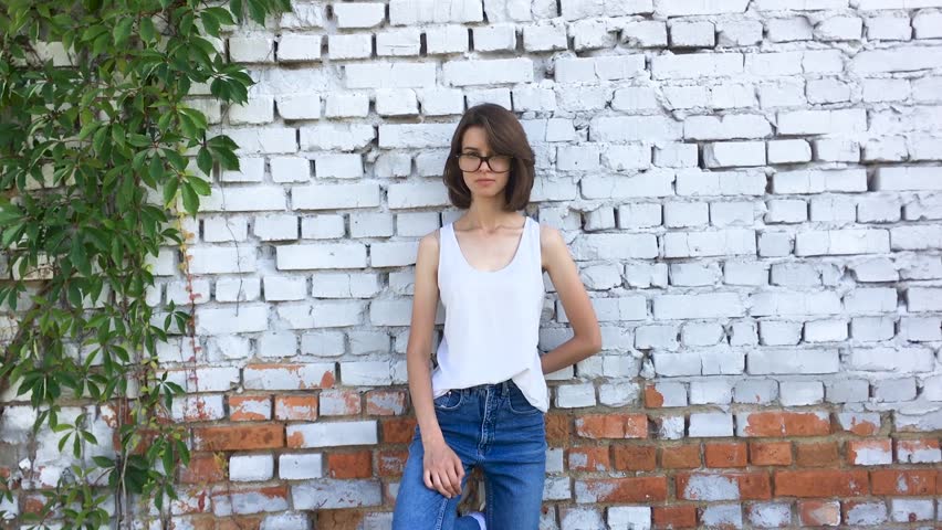 Teen girl with hipster glasses is smiling.