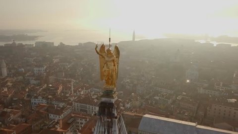 Golden statue atop campanile San Marco in Venice