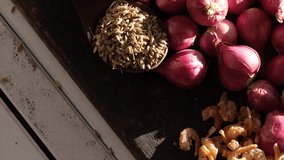 Close up footage of shallot with other spices on wooden table. Selective focus.