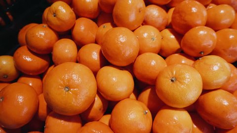 Detailed 4k ProRes shot of a freshly picked orange tangerines in the grocery department of the organic supermarket.