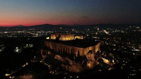 Aerial drone detail night video of iconic Acropolis hill and the Parthenon a masterpiece of ancient Western civilisation, Athens historic centre, Attica, Greece