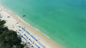 Aerial video footage of sunny Patong Beach in Thailand, Phuket, showing the entire city landscape view from the drone.