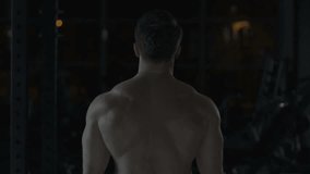 Muscular bodybuilder showing his back double biceps, training in gym, slow-mo - Powered by Shutterstock - Get 15% off with code: PIKWIZARD15