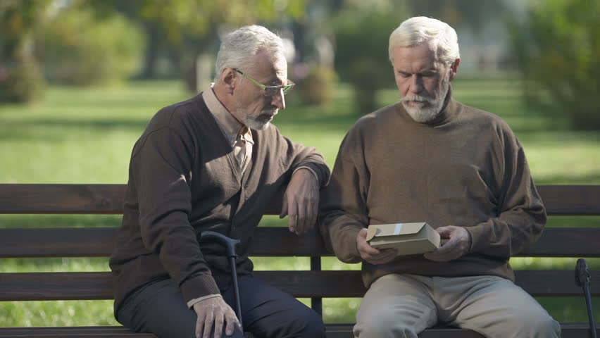 Two senior brothers looking at photo and remembering relatives, memories Royalty-Free Stock Footage #1021623346