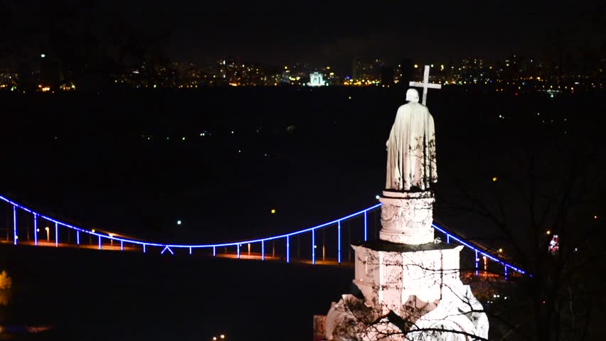 Sculpture of Prince Vladimir view of the bridge over the Dnieper in the evening in Kiev, Ukraine