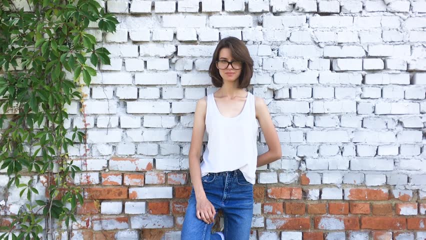 Slow motion. Teenager girl smiles when she walks.