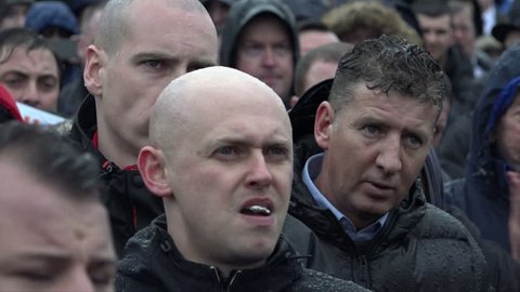 Birmingham, United Kingdom (UK) - 02 06 2016: Far right skinheads in a crowd applauding