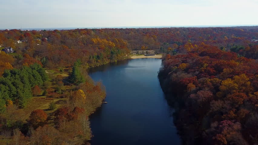 Aerial, beautiful changing colors along Lake Mohegan beachfront, New England