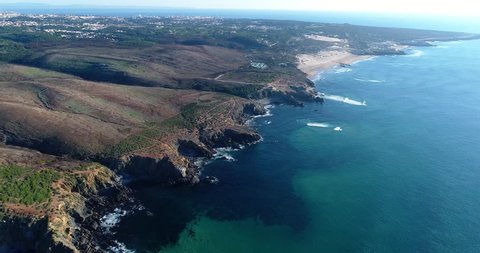 Aerial view of the Guincho Beach (Praia do Guincho) with the city of Cascais on the background; Concept for travel in Portugal and visit Cascais