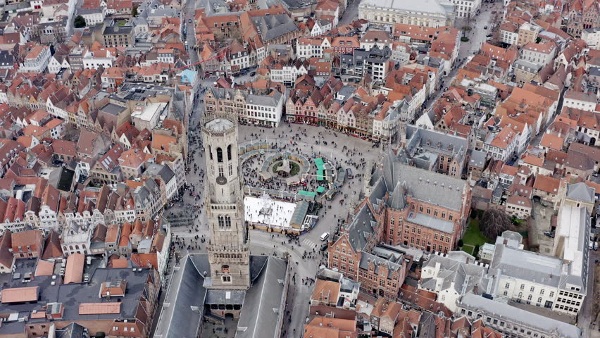 Aerial view of Bruges iconic Market Square with Belfry of Bruges medieval bell tower historical landmark in city town center famous Europe tourist destination in Belgium HD - 4K