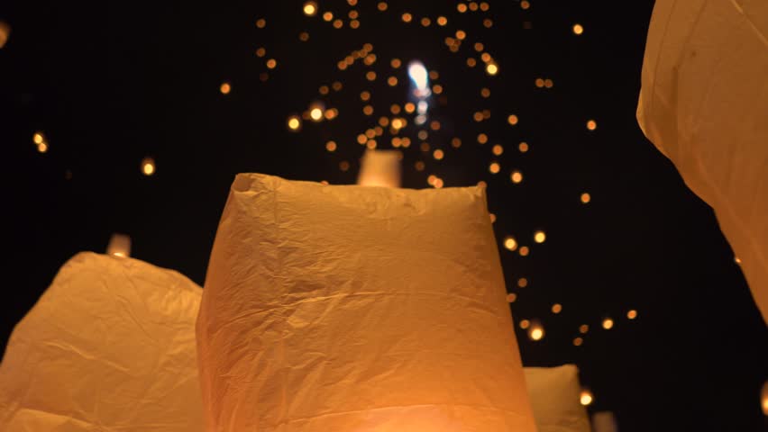 Floating lanterns in the night sky. Launching Sky Lantern. Yee Peng Festival, Loy Krathong celebration. Royalty-Free Stock Footage #1021682980