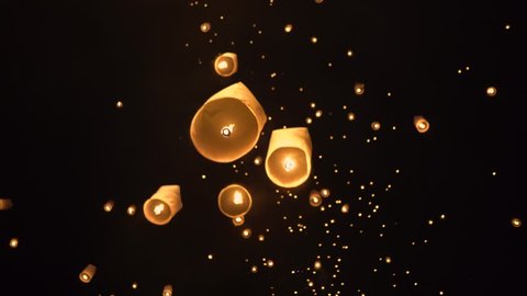 Floating lanterns in the night sky. Launching Sky Lantern. Yee Peng Festival, Loy Krathong celebration.