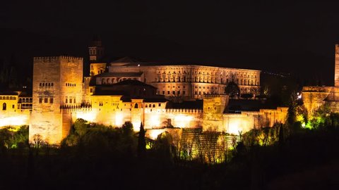 Panoramic view of the famous Alhambra Royal Palace by night from the best viewpoint. This site is known as one of the most beautiful in the world and is a Unesco heritage. Granada, Andalucia, Spain.