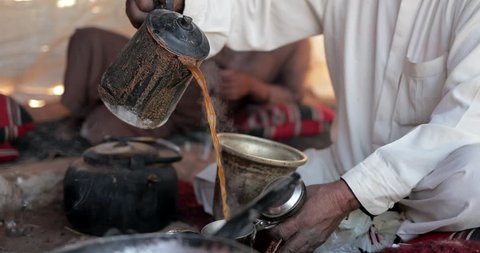A Bedouin Man Cooks Coffee and Tea In A Traditional Way In The Wadi Rum, Jordan
