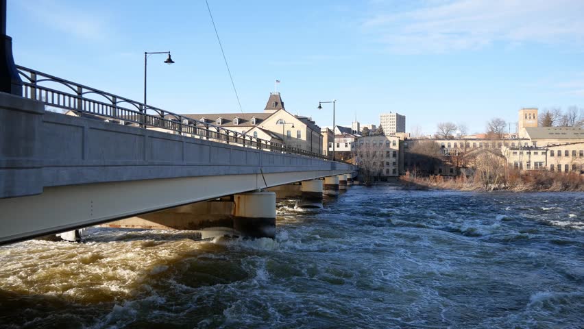 Water flowing under a bridge during the day in Appleton, Wisconsin.