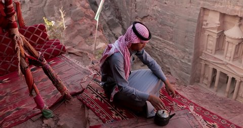 A Bedouin Man Cooks Coffee In A Traditional Way In The Wadi Rum Sunset, Jordan. Jordan Petra Facade Of The Treasury Building The Ancient Nabatean
