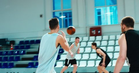 High school team playing basketball indoors, practicing combinations and drills. 4K UHD