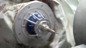 High-speed spindle of a dental milling machine in a laboratory for prosthesis and crowns milling. It is starting spinning and then stopping. Closeup video recording.