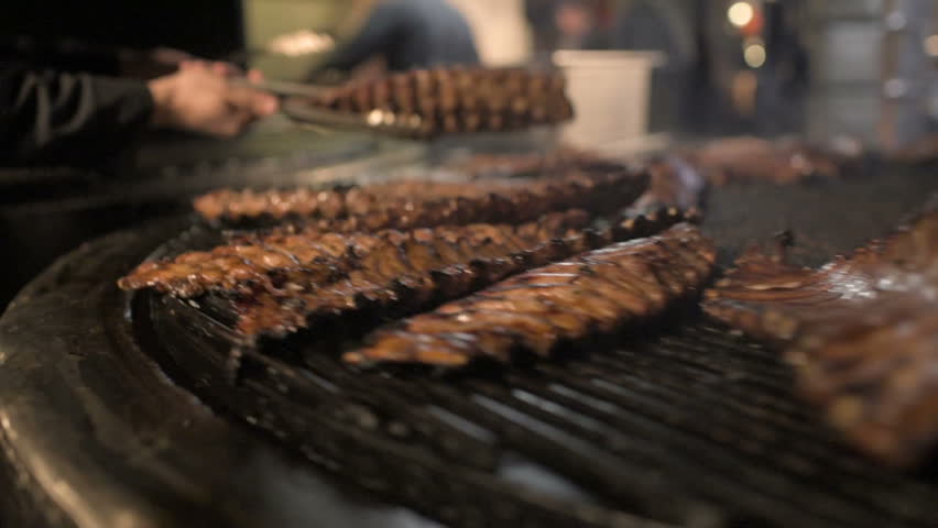 the roast pork ribs rotate on the grill. roast pork. street food