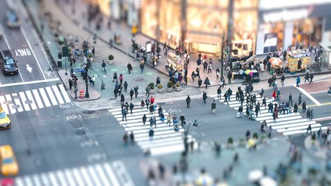 New York City, USA - April 6, 2018: Timelapse, time lapse of high angle, aerial view of NYC Herald Square midtown with crowd of people crossing crosswalk at night with tilt and shift effect