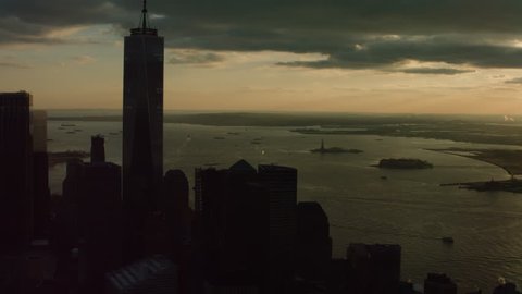 Aerial view of Manhattan skyline with view of the river, New York City, dark sunset light. Wide shot. 4k shot with a RED camera.