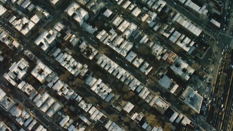 Top down aerial view of a quiet, residential area with homes and streets in New York City, during a bright sunny day. Shot on 4k RED camera on helicopter.