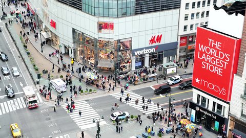 New York City, USA - April 6, 2018: High angle aerial view of Macy's, Verizon and H&M stores at intersection of NYC Herald Square midtown with people crossing crosswalk, traffic cars