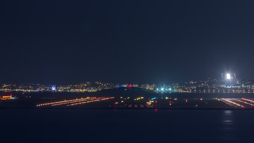 Aerial view of the airport of Nice in South France timelapse. Planes landing and taking off with bright lights | Shutterstock HD Video #1021765318