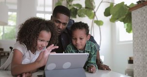 African American family using digital tablet together