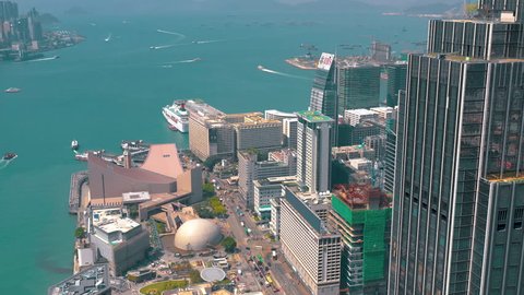 HONG KONG - MAY 2018: Aerial view of Victoria bay at sunny day from Kowloon district side in 4k. Skyscrapers on the waterfront