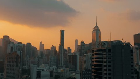 HONG KONG - MAY 2018: Aerial view of a sunset over Victoria Peak, Victoria Harbour, Hong Kong downtown. Tightly built skyscrapers.