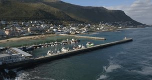 4K summer day aerial drone footage of spectacular Kalk Bay harbour, boats, lagoon with beach. Kalk Bay is Cape Town residential suburb on False Bay of Cape Peninsula, Western Cape, South Africa