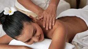 Asian woman are relaxing neck massage in the Spa Salon. Thai massage for health. Select focus hand of masseuse
