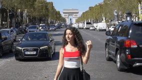 Model in Paris flirting with the camera in slow-motion at Champs-Élysées.