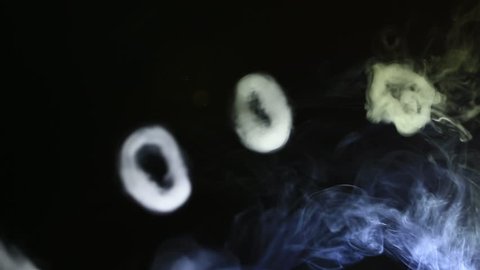 Smoke Rings Over Dark Background Created by Vaping e-Cigarette