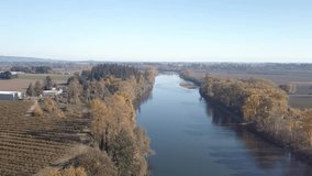 aerial footage of the willamette river south of Portland Oregon and the surrounding farm land. drone moving forward over river.