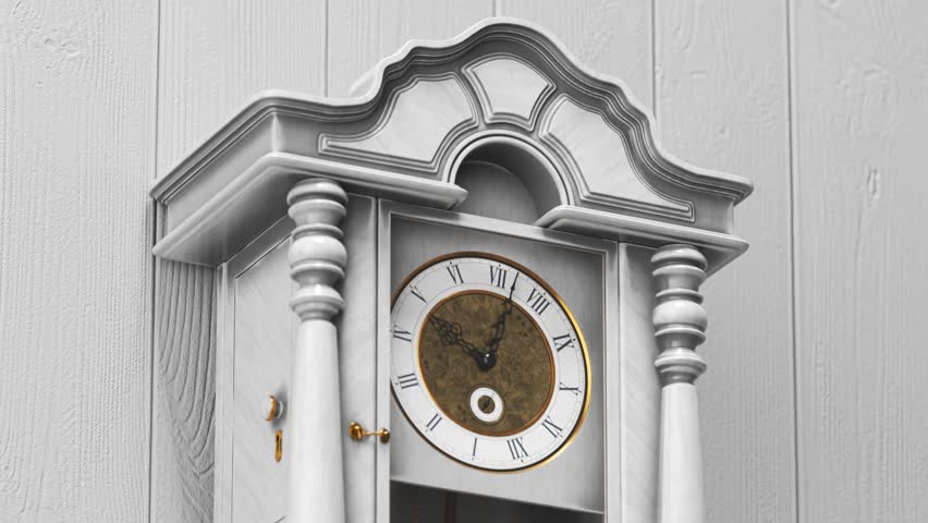 Beautiful white wooden luxurious vintage clock hanging on a bright wall made out of planks. Priceless golden parts and ornaments shining in studio lights. Symbol of ruthless time passing 4KHD
