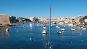 Malta Kalkara morning yacht harbor sailing chips fishing boats historic fortress beautiful bay video shot from drone