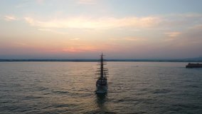 A bird's eye view of Ortigia Island at sunset. Sailing ship out of the bay. Sicily - Powered by Shutterstock - Get 15% off with code: PIKWIZARD15