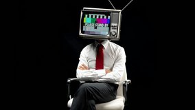 smart businessman with a television as a head. the tv has please stand-by on the screen