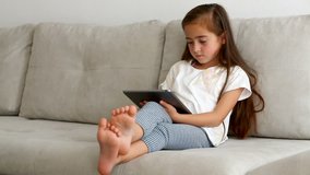 girl with a tablet on the couch