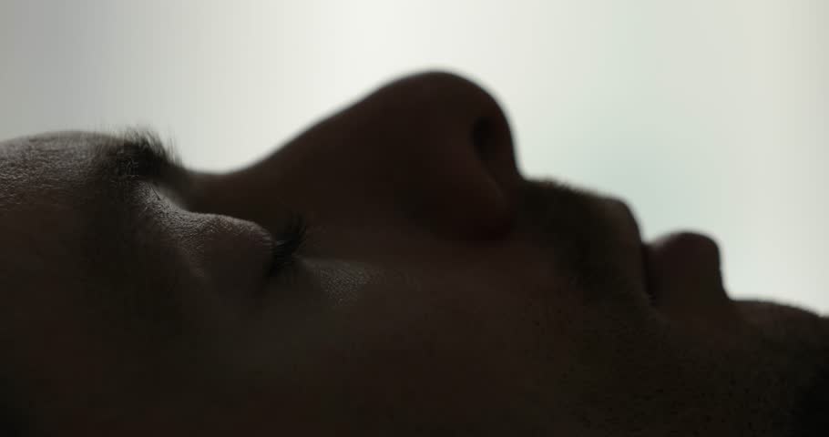 Closeup of male face and eye wake up in bed at the morning Royalty-Free Stock Footage #1021854232