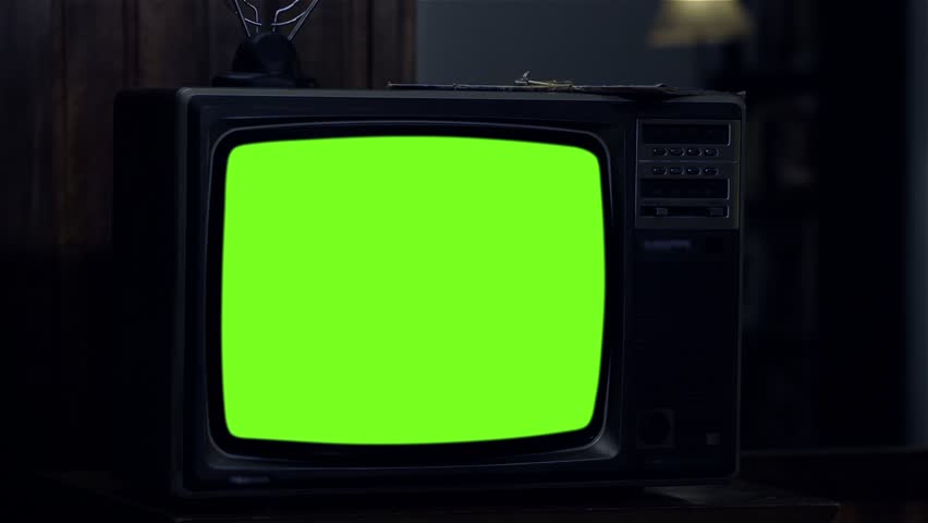 Old Television Set Turning On Green Screen with Static Noise. Night Tone. You can replace green screen with the footage or picture you want. You can do it with “Keying” (Chroma Key) effect. | Shutterstock HD Video #1021884256