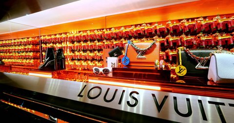 LOS ANGELES, CALIFORNIA, USA - NOVEMBER 25, 2018: Window with expensive goods at Louis Vuitton Luxury boutique shop on Rodeo Drive, Beverly Hills, Los Angeles, California, 4k